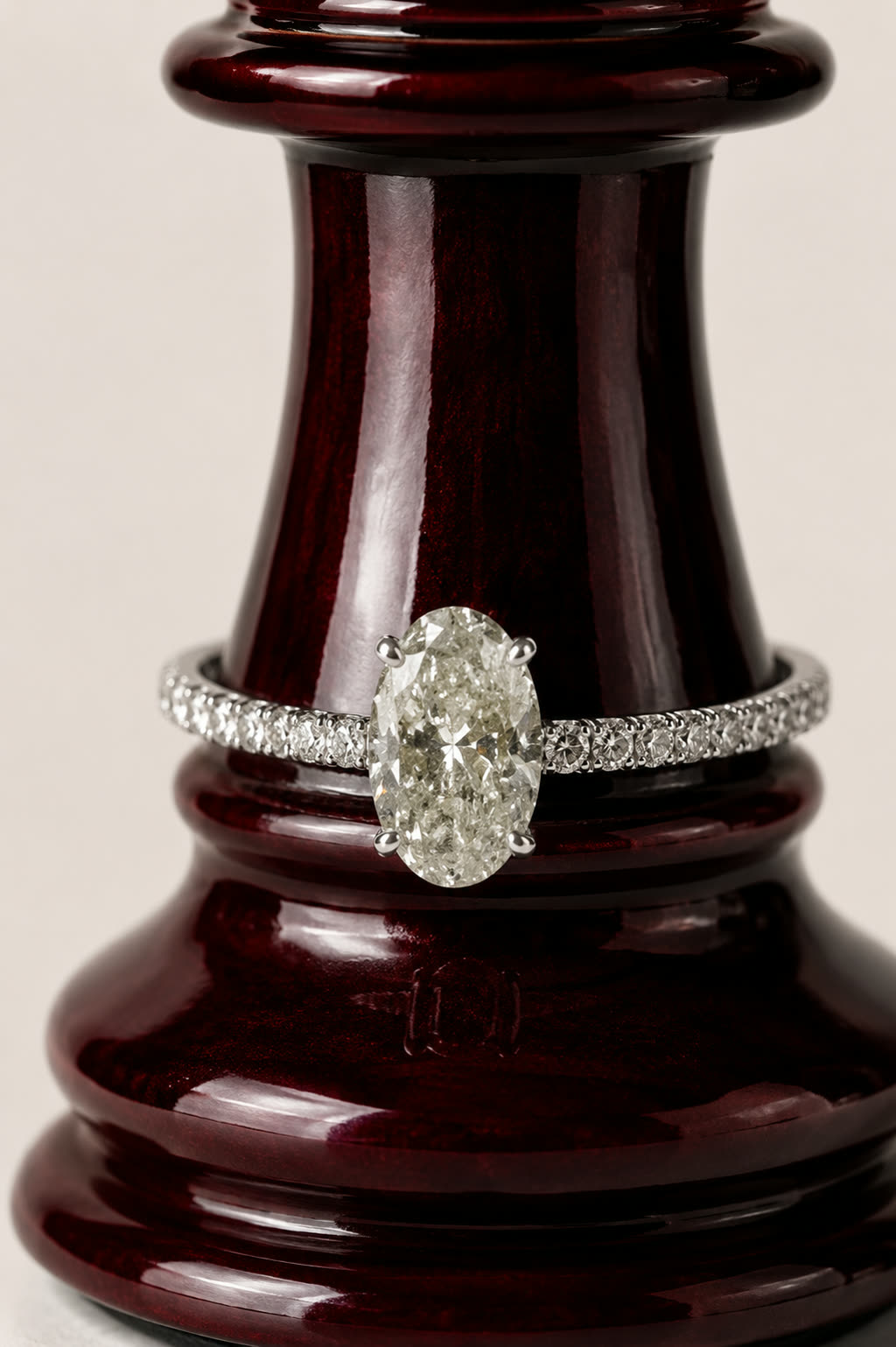 The ring produced on a dark burgundy lacquered stand