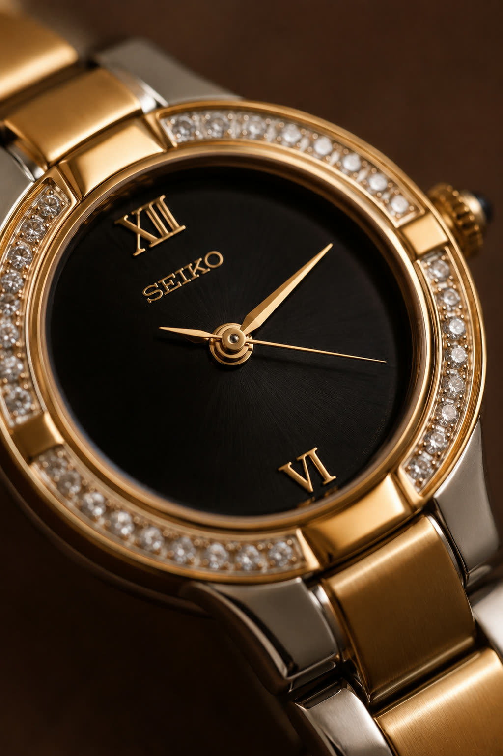 A two tone diamond bezel dress watch with a black dial, produced as a clean macro image