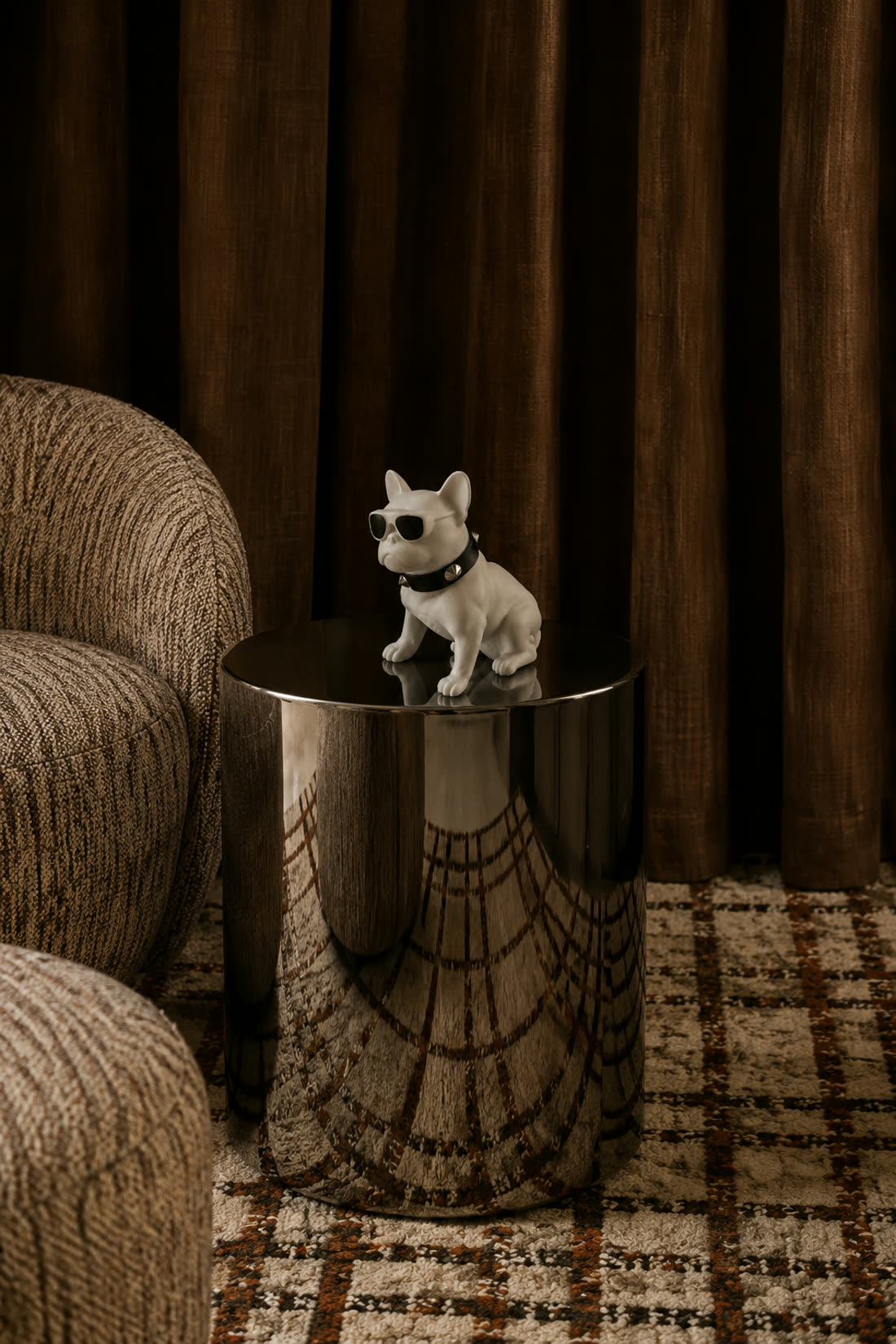 The figurine styled on a chrome side table beside a boucle armchair and a patterned rug