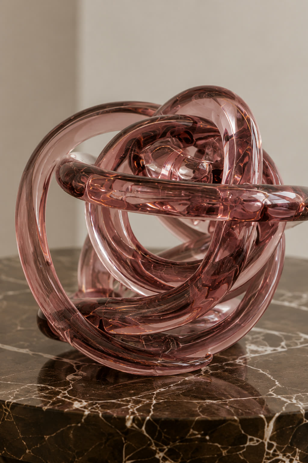The same rose glass knot sculpture, a closer view showing the depth of the coiled glass